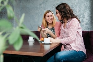 Girls sitting and chatting in a cafe